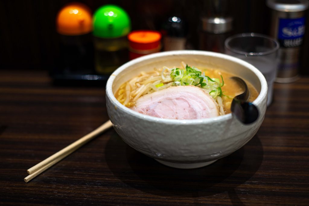 A photograph of a bowl of ramen noodles topped with an egg.