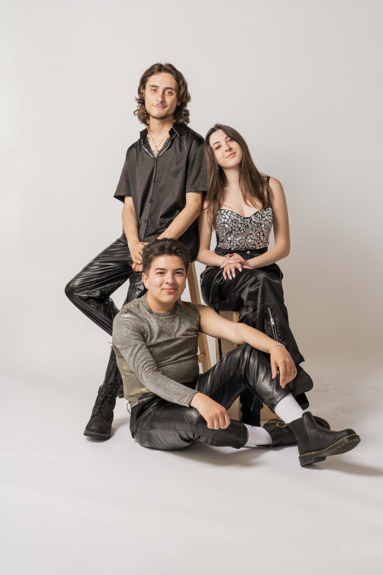 A group portrait of three young people.