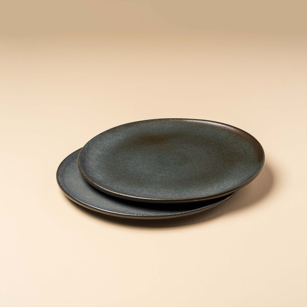 Product photograph of two dark grey ceramic paltes.