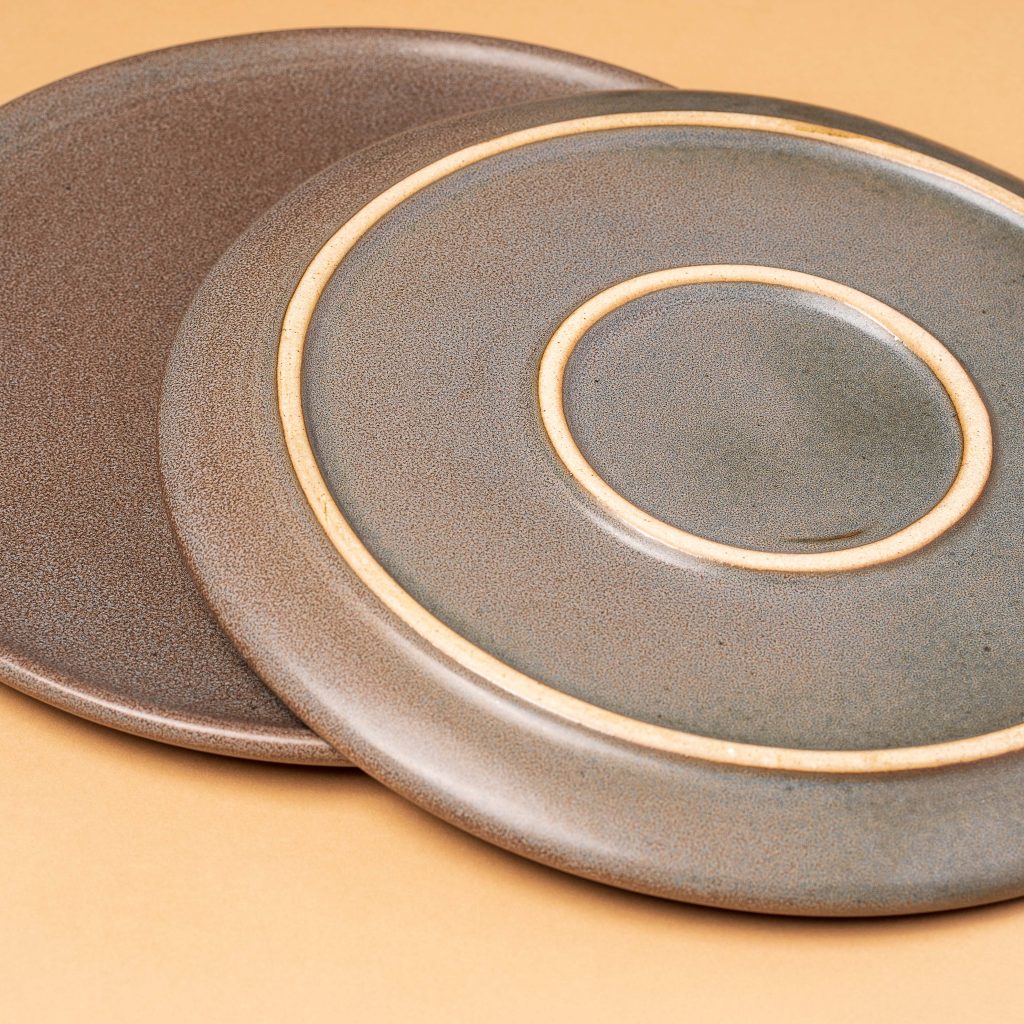 Product photo of two grey ceramic plates.